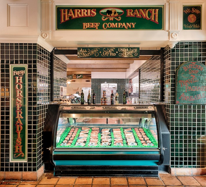8ddb3100-851f-402a-a756-68ef90640aee Stocked meat case at Harris Ranch Inn & Restaurant, Sign above: Harris Ranch Beef Company, All Natural, Grain Fed, USDA Choice. Green tiles on wall with white grout surround meat case. Sign on left says: Fresh Horseradish